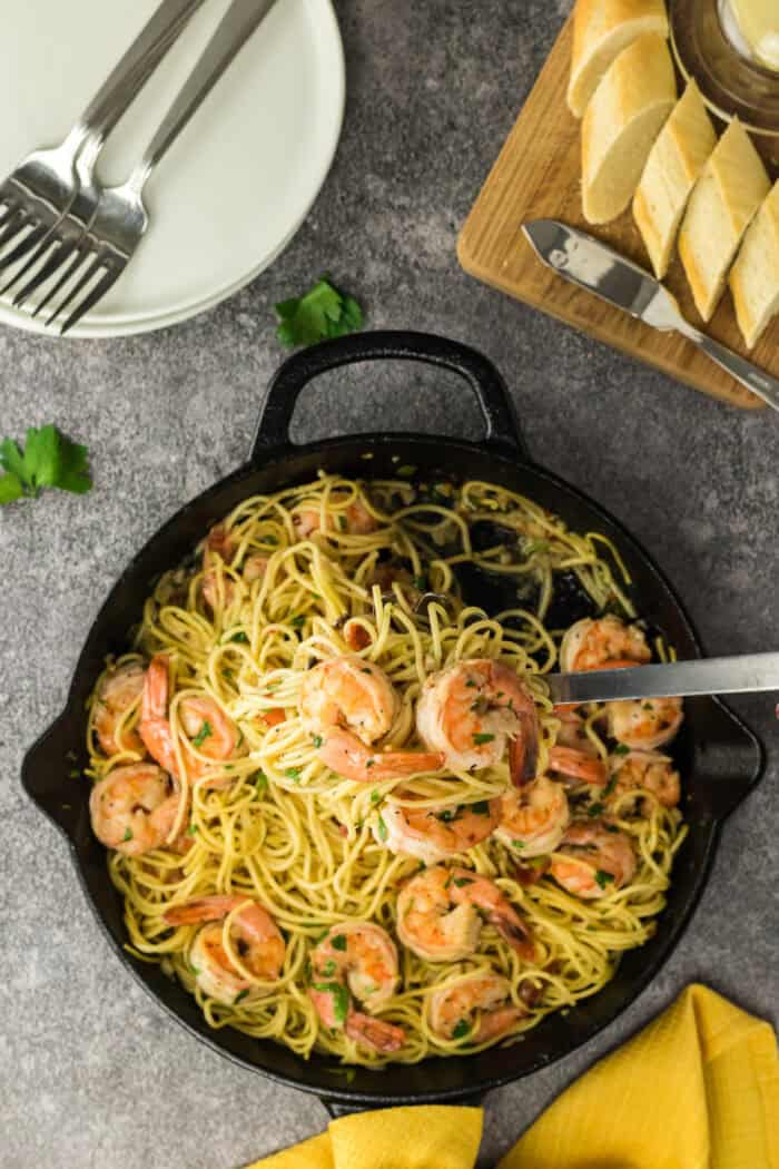 This delicious and Easy Shrimp Scampi Pasta Recipe is ready in a total of 15-minutes! Shrimp Scampi and pasta in a skillet