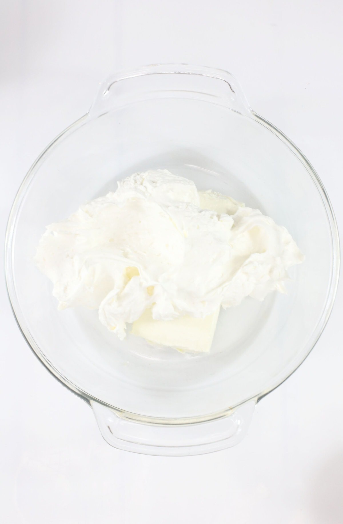 Combining the cool whip and cream cheese.