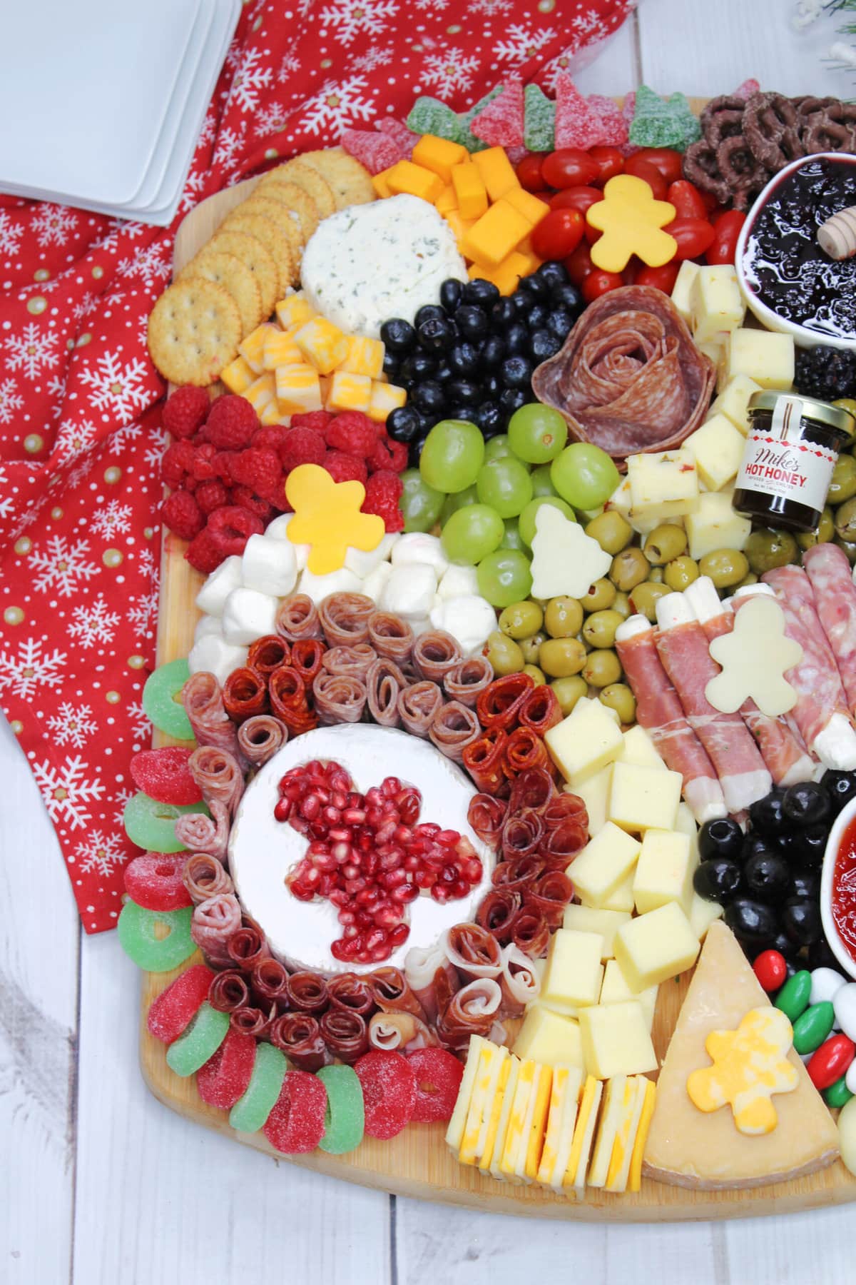 Christmas Charcuterie Board on a red snowflake cloth.