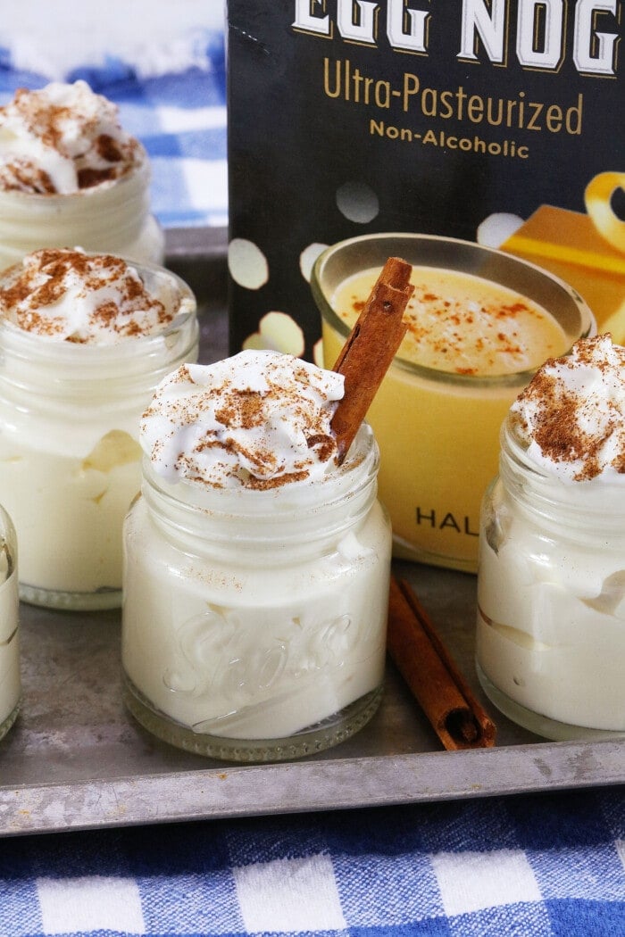 Eggnog Pudding Shots topped with cinnamon.