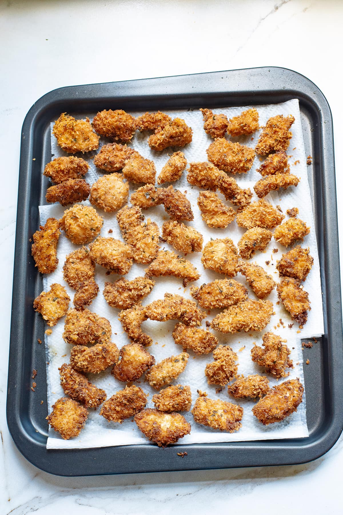 Pieces of fried chicken bites on paper towels