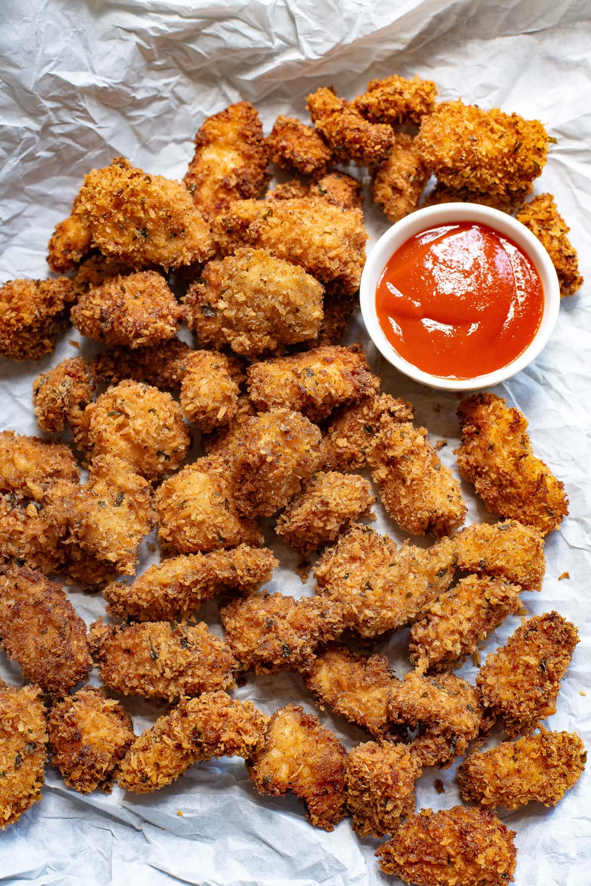 Overhead view of popcorn chicken with a dish of ketchup