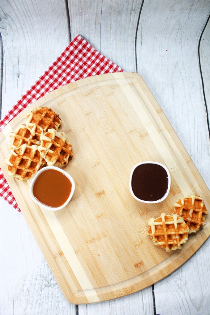 Adding the sauces and waffles onto the board.