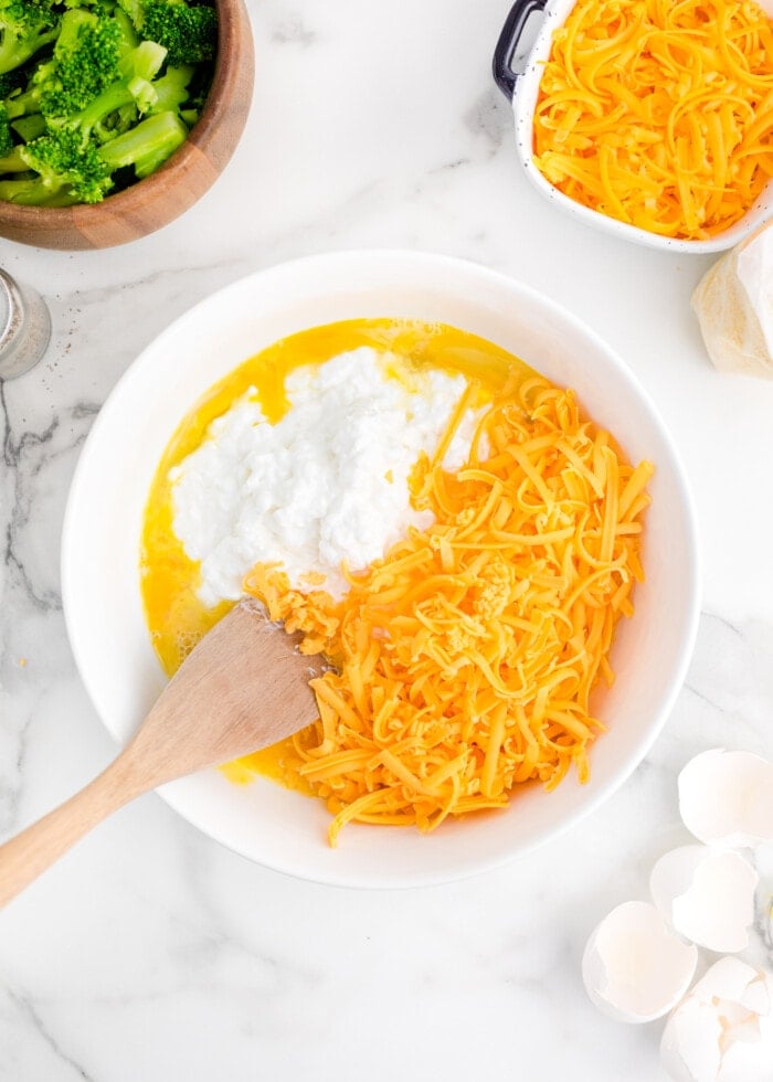 Adding in the cottage and cheddar cheese.