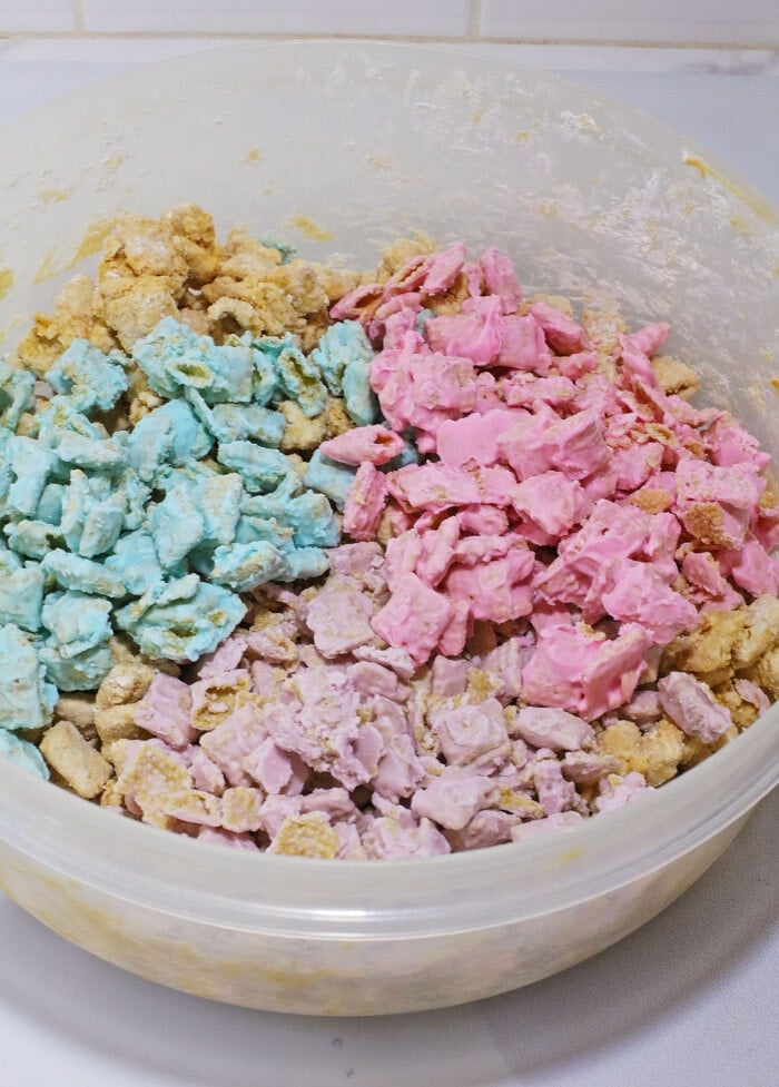 Adding the colored cereal into the Easter Puppy Chow.