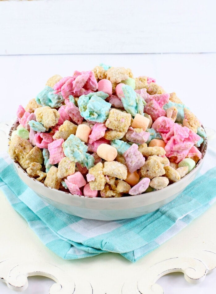 Easter Puppy Chow on a blue cloth.
