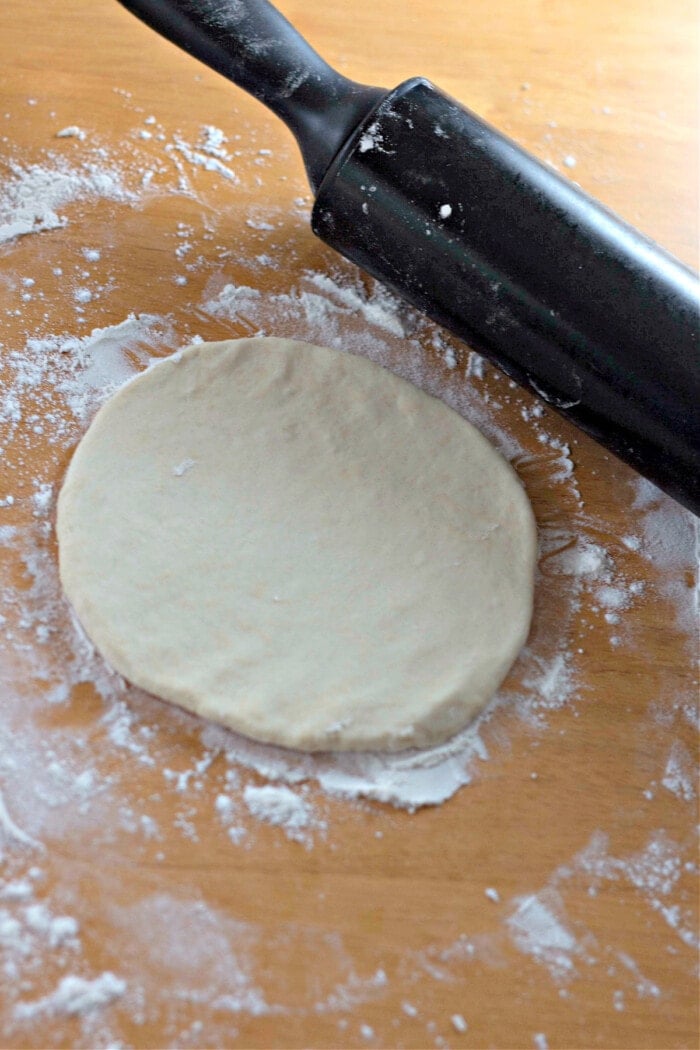 homemade flour tortillas rolled with black rolling pin