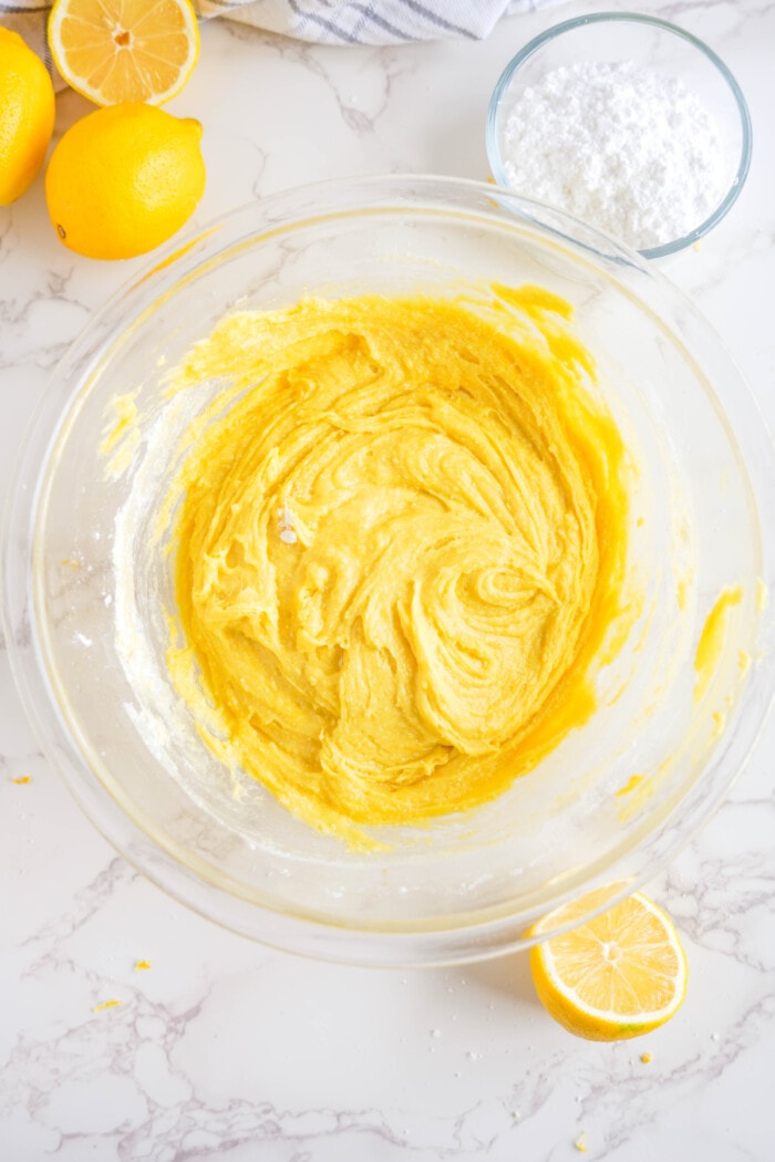 lemon cookie batter mixed in clear glass bowl