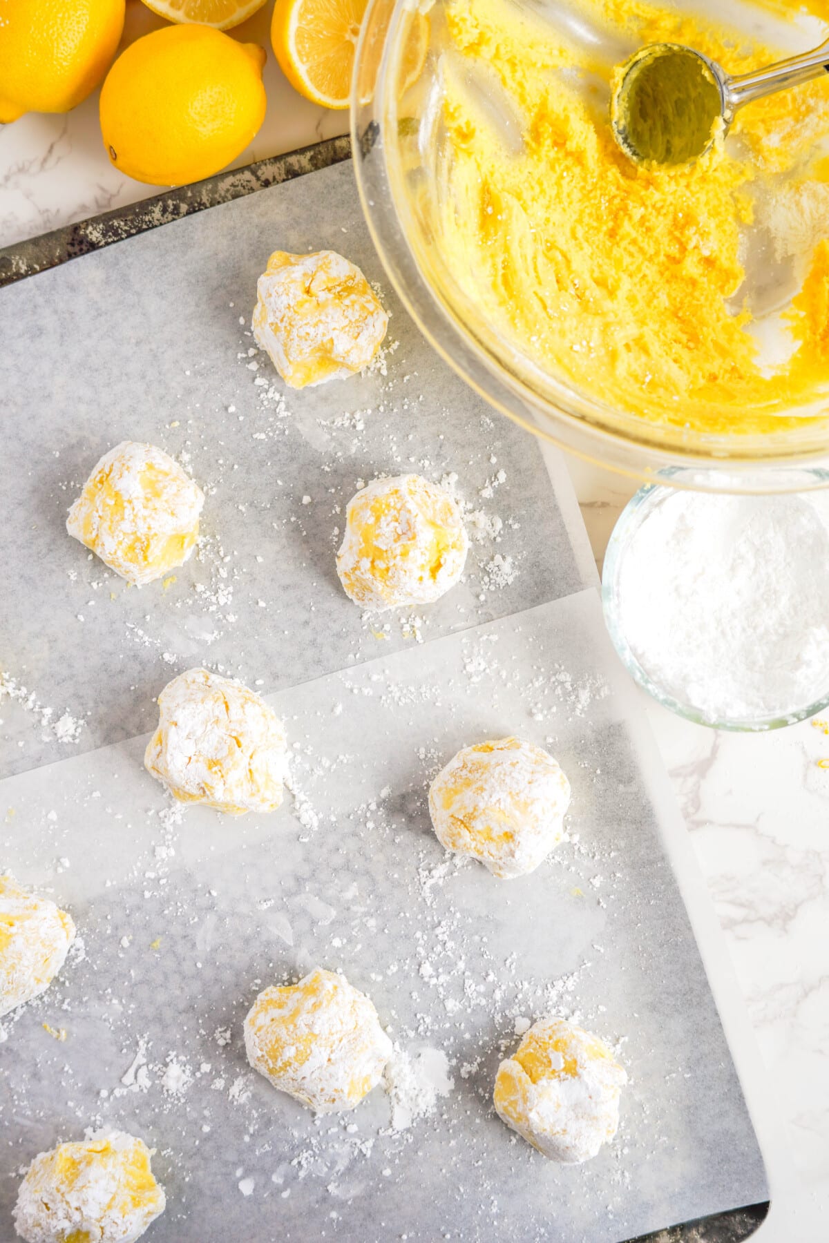 lemon crinkle cookies on baking sheet