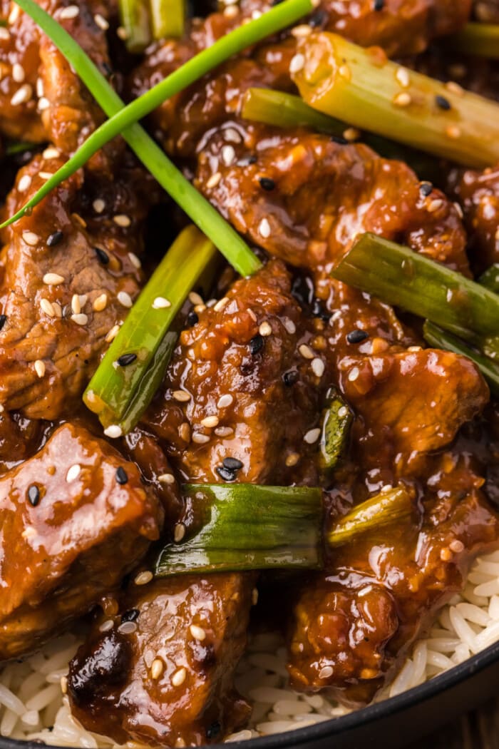 close up image of PF Chang's Mongolian Beef with rice in black bowl