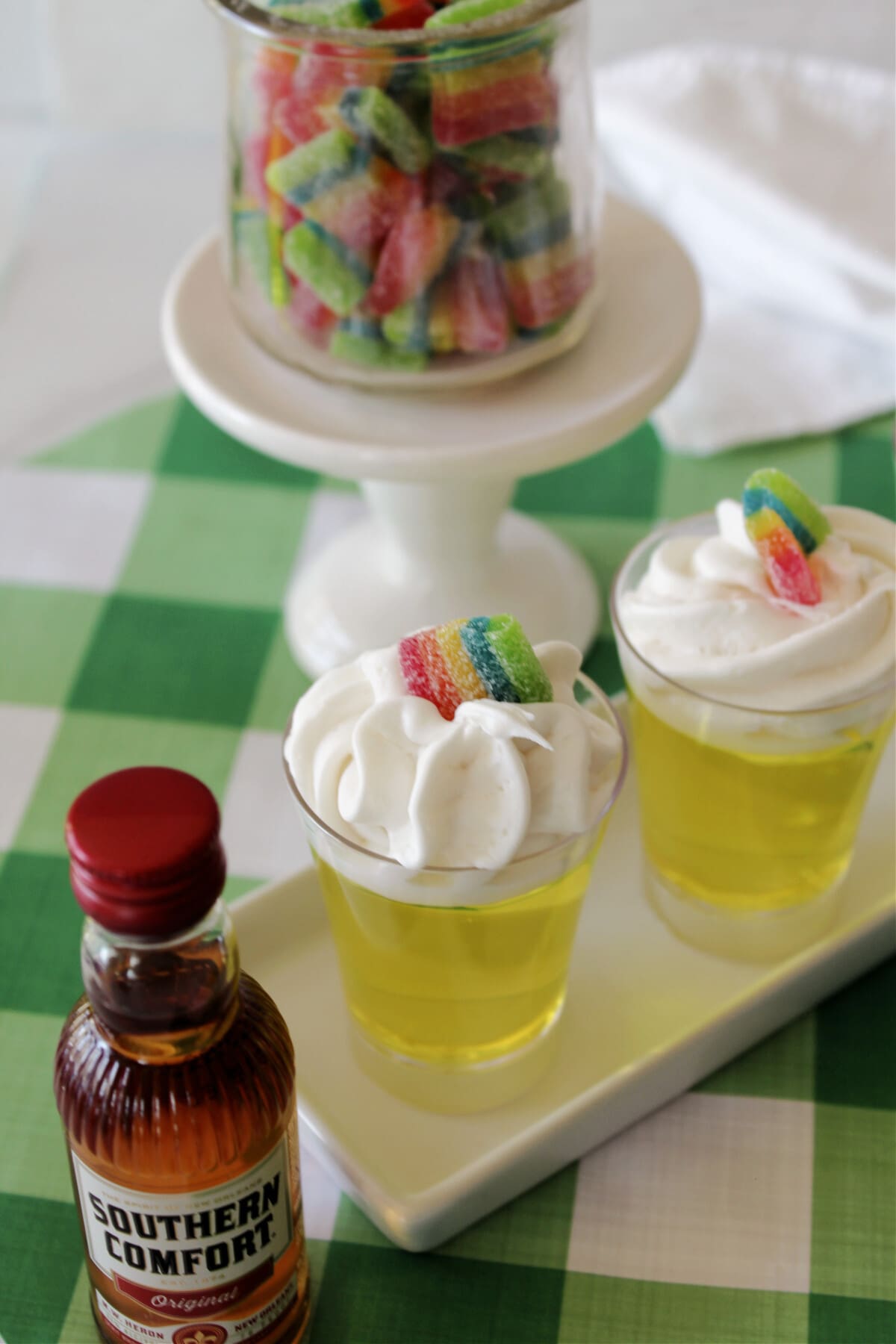 Pot Of Gold Jello Shots with a mini bottle of whiskey next to them.
