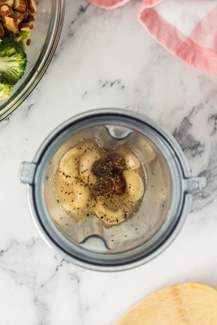 Cashews, dates, and seasonings in a blender