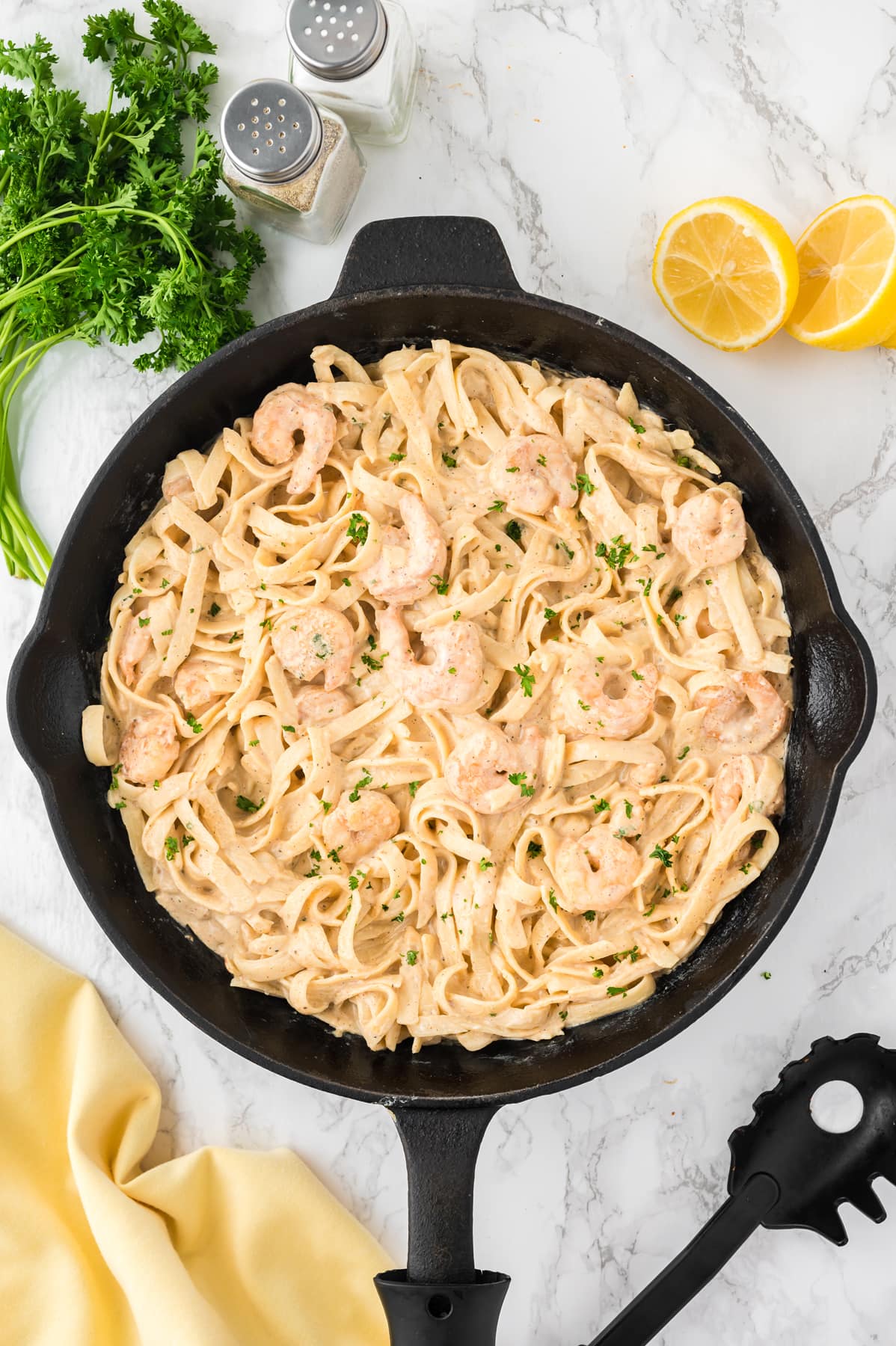 Overhead view of creamy shrimp pasta in a skillet