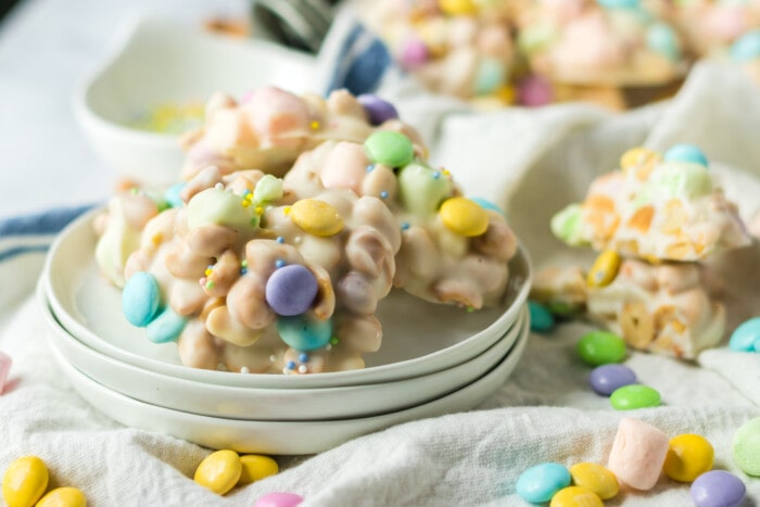 Easter Crockpot Candy on a stack of plates.
