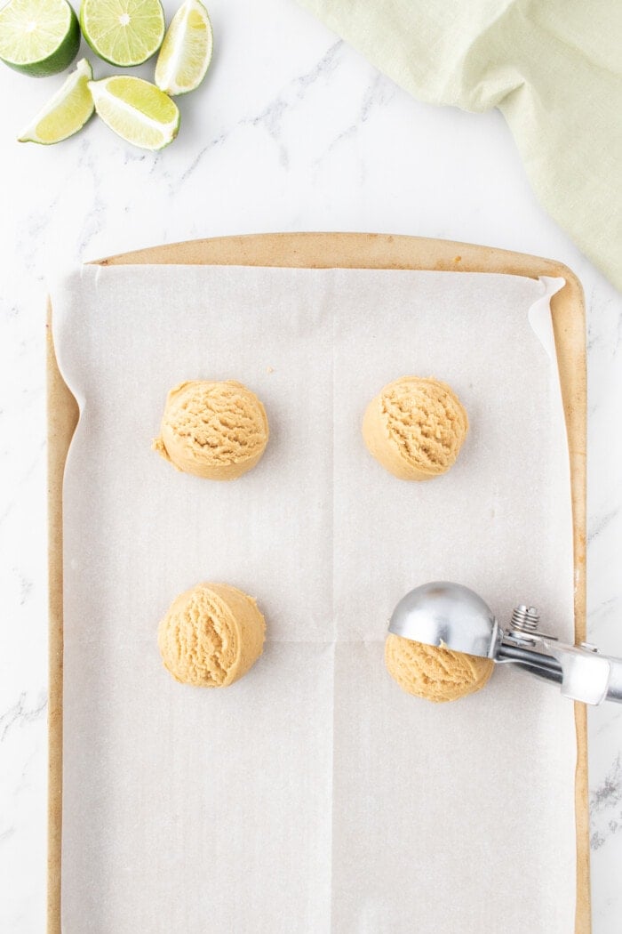 Adding the Key Lime Pie Cookies dough balls on the sheet pan.