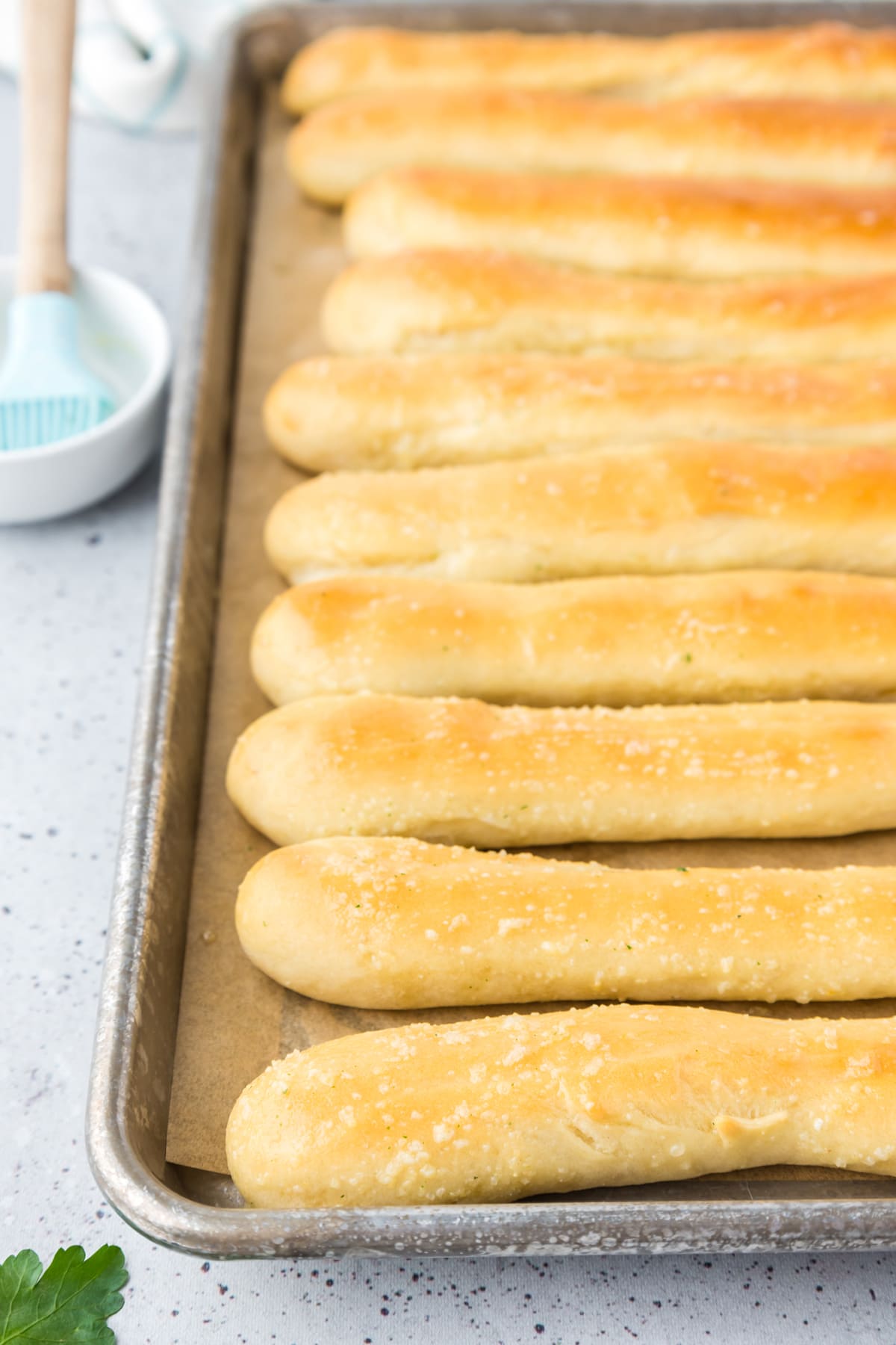 Homemade breadsticks on a baking sheet