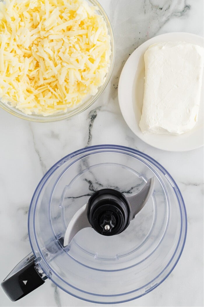 food processor with cream cheese and white cheddar cheese