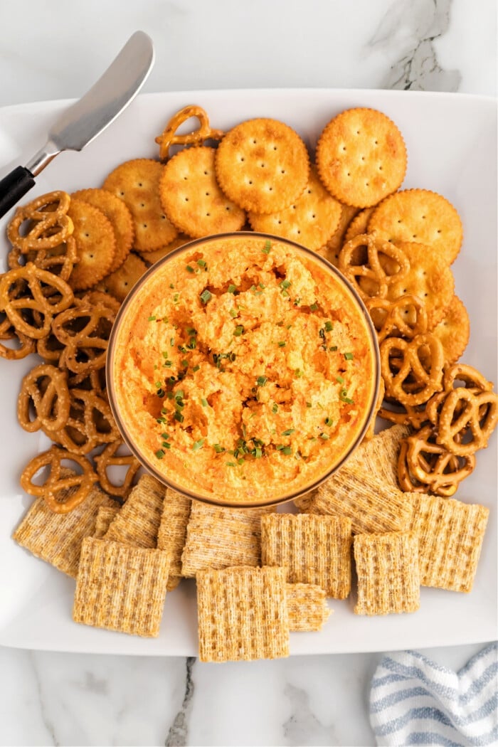 pimento cheese in bowl with crackers on white plate