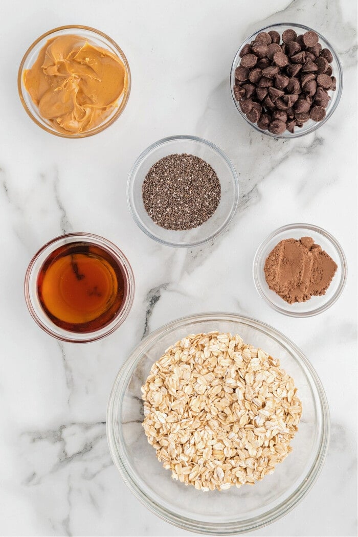 ingredients needed to make no bake protein balls in clear glass bowls