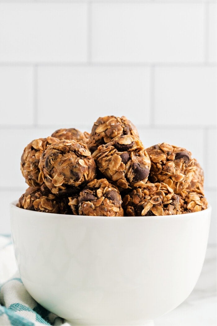 chocolate chip protein balls in a white bowl with green napkin