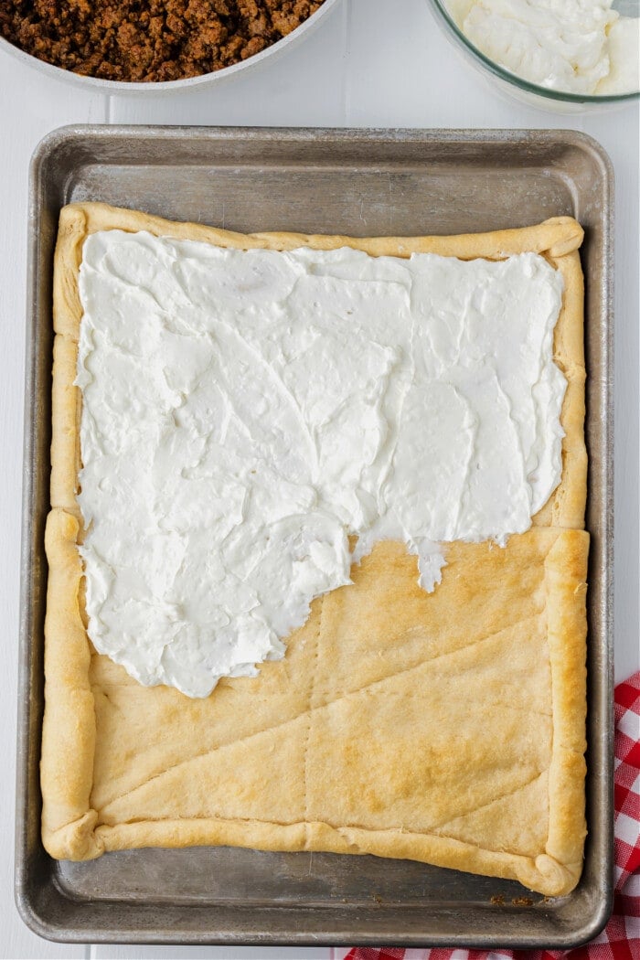 cream cheese mixture spread on cooked crescent roll crust 