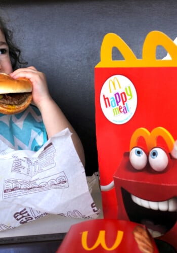 Girl eating burger from McDonalds