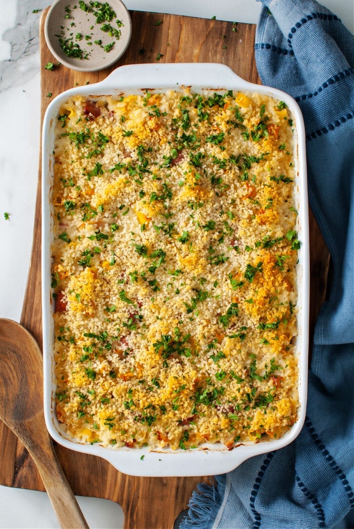 cooked cordon bleu casserole in white casserole dish with parsley