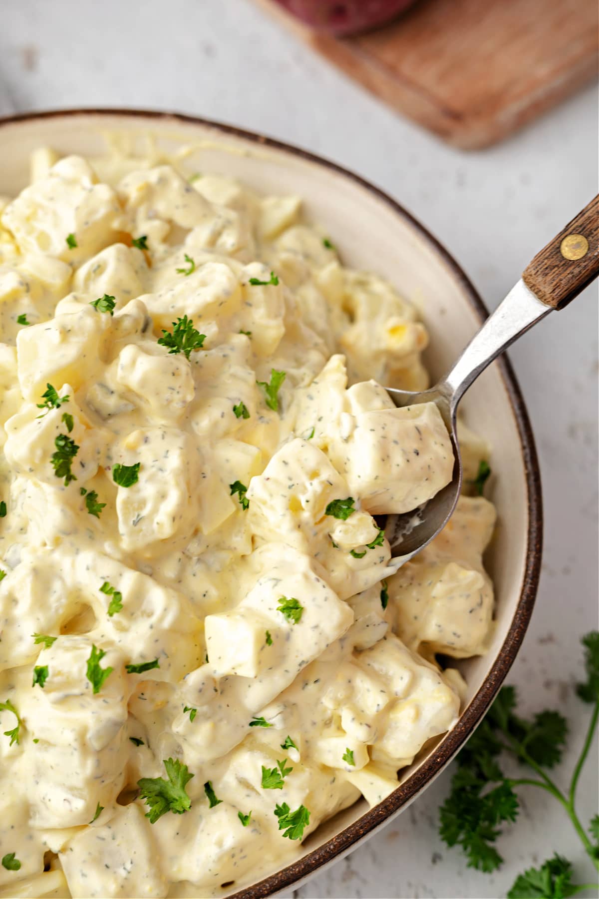 creamy potato salad in bowl with spoon