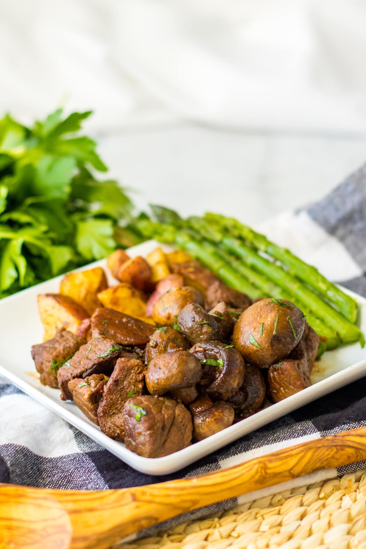 Crockpot Steak Bites with Mushrooms with a side of asparagus.