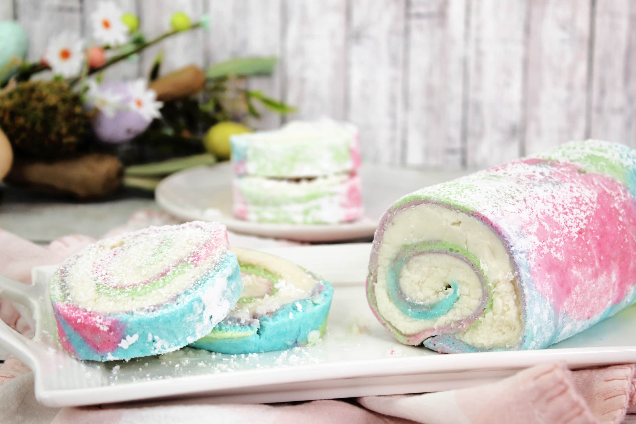 Easter Cake Roll on a white cutting board.