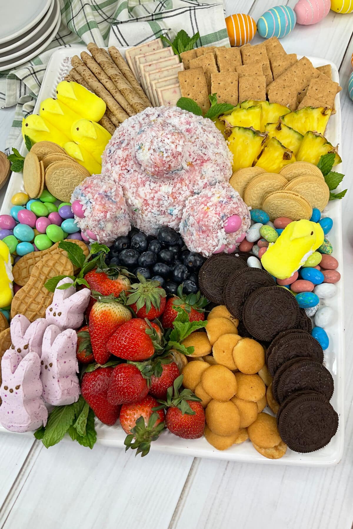 Easter Charcuterie Board with easter eggs around it.