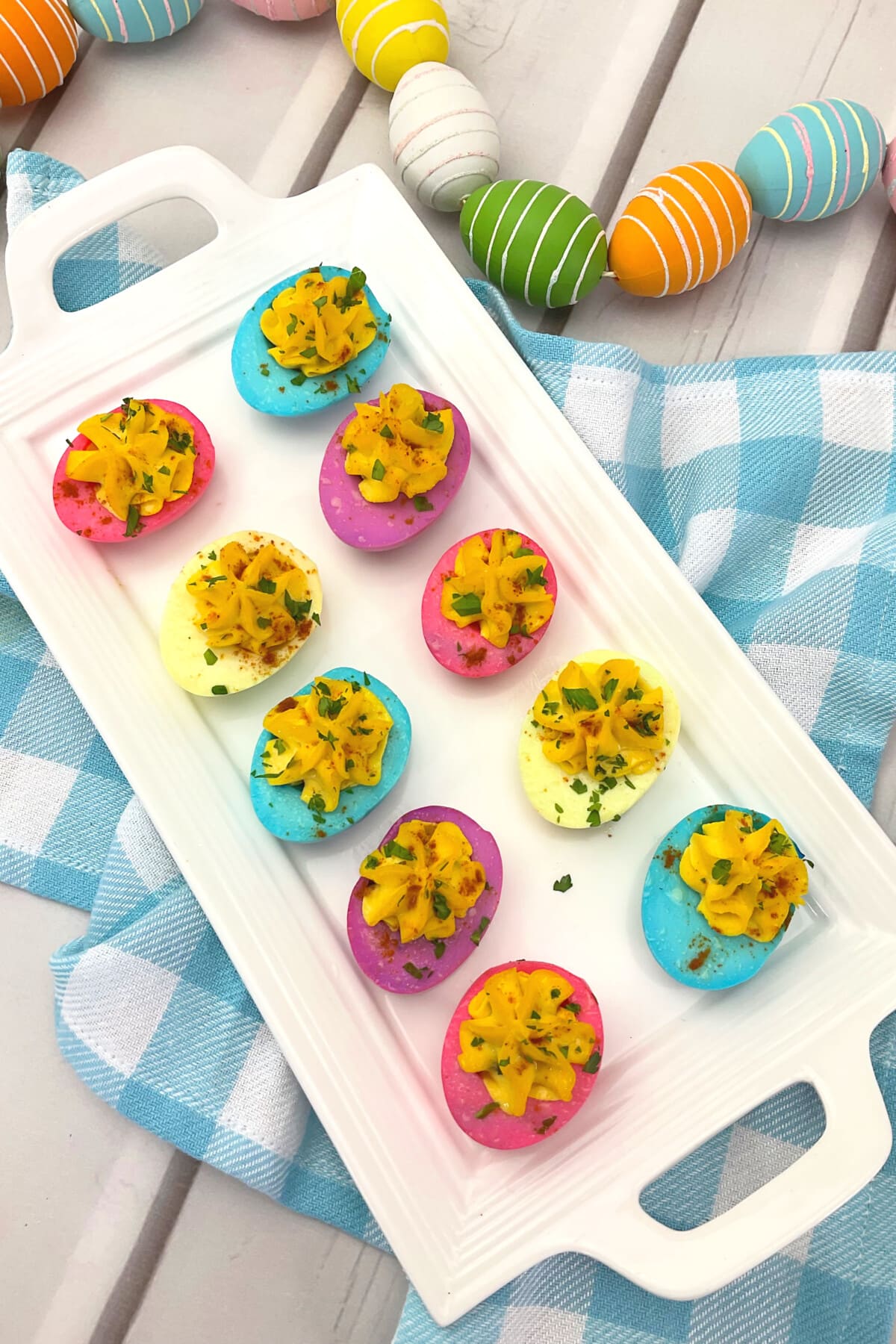 Easter Deviled Eggs on a wooden table.
