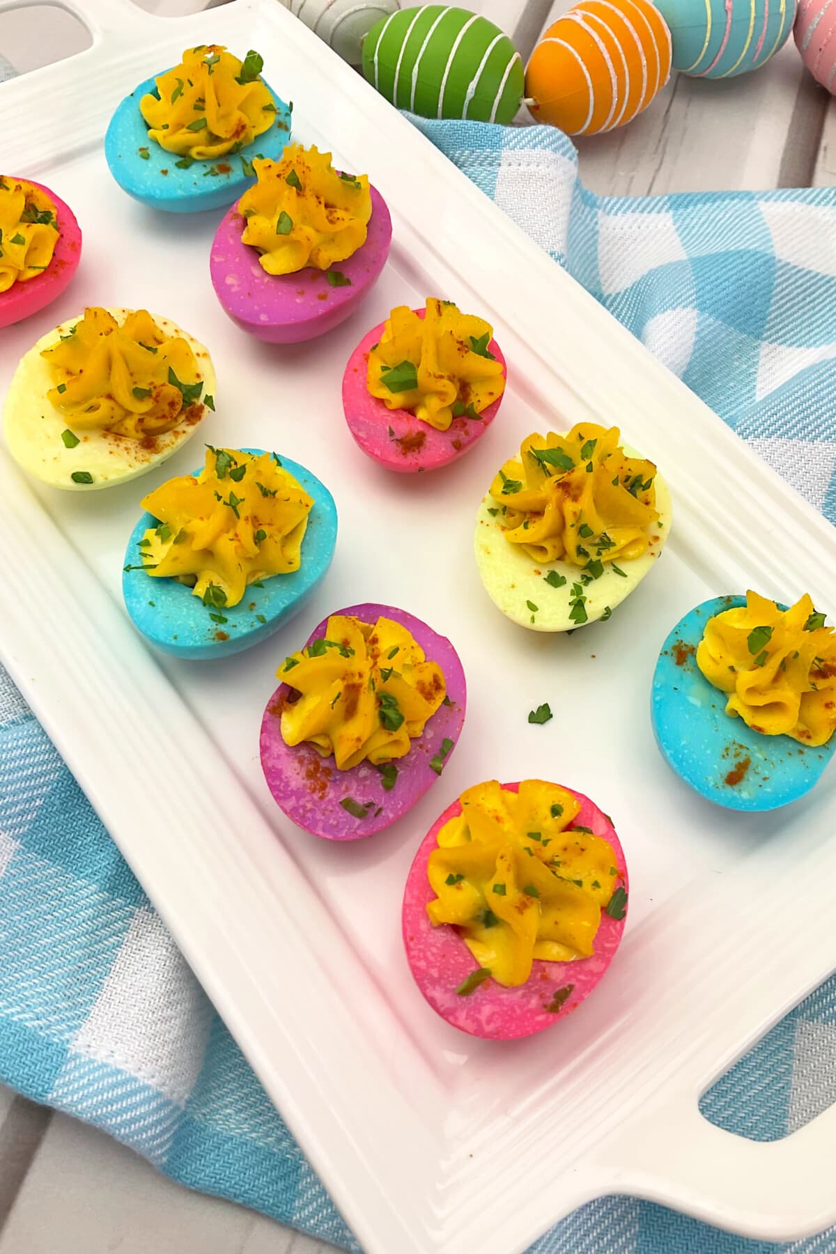 Easter Deviled Eggs on a checkered cloth.