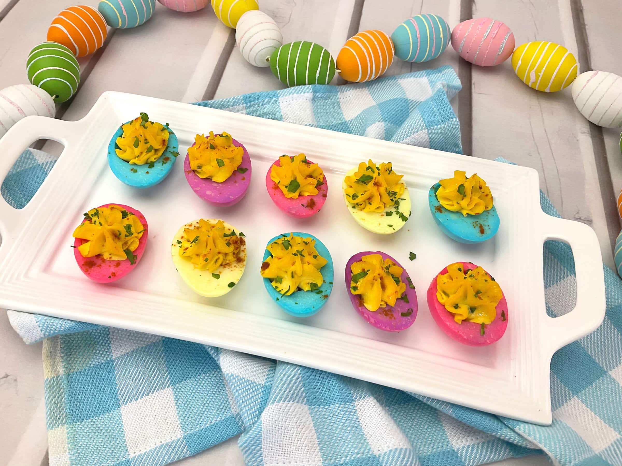 Easter Deviled Eggs on a white tray.