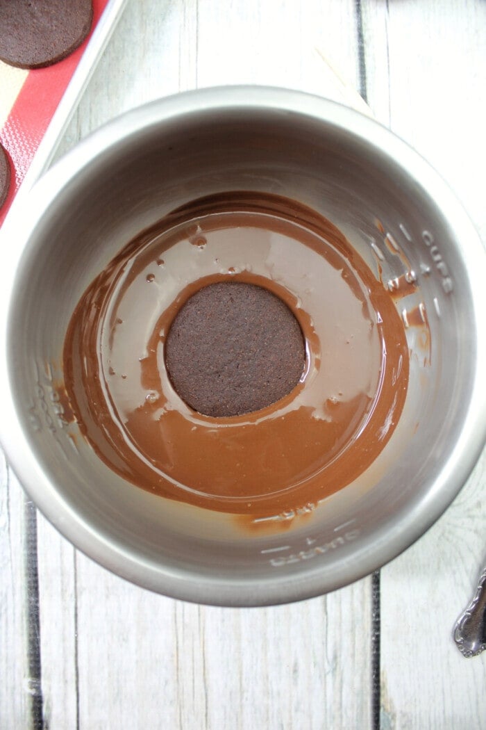Dipping the cookies in chocolate.