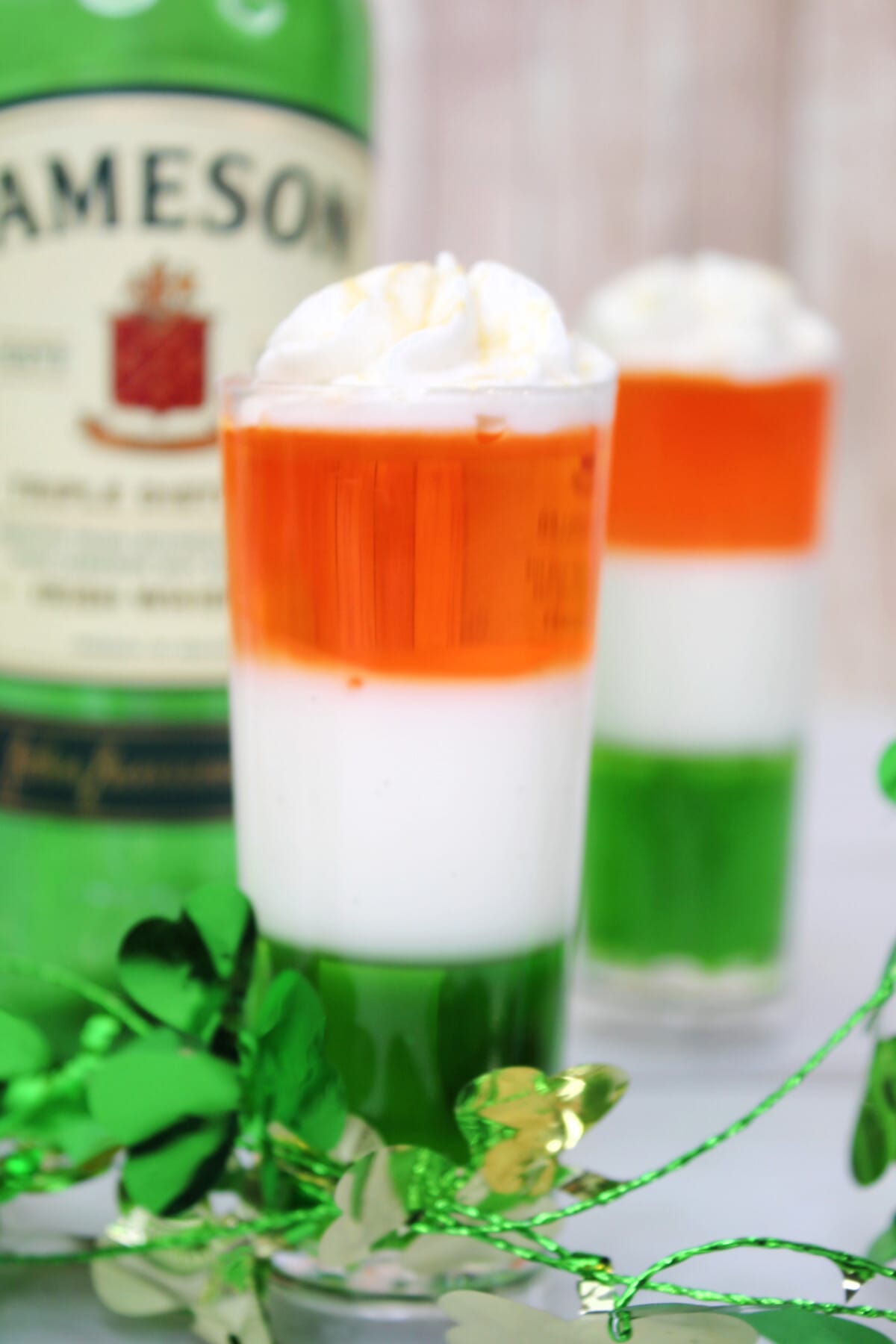 Irish Flag Jello Shots with a bottle of Jameson in the back.