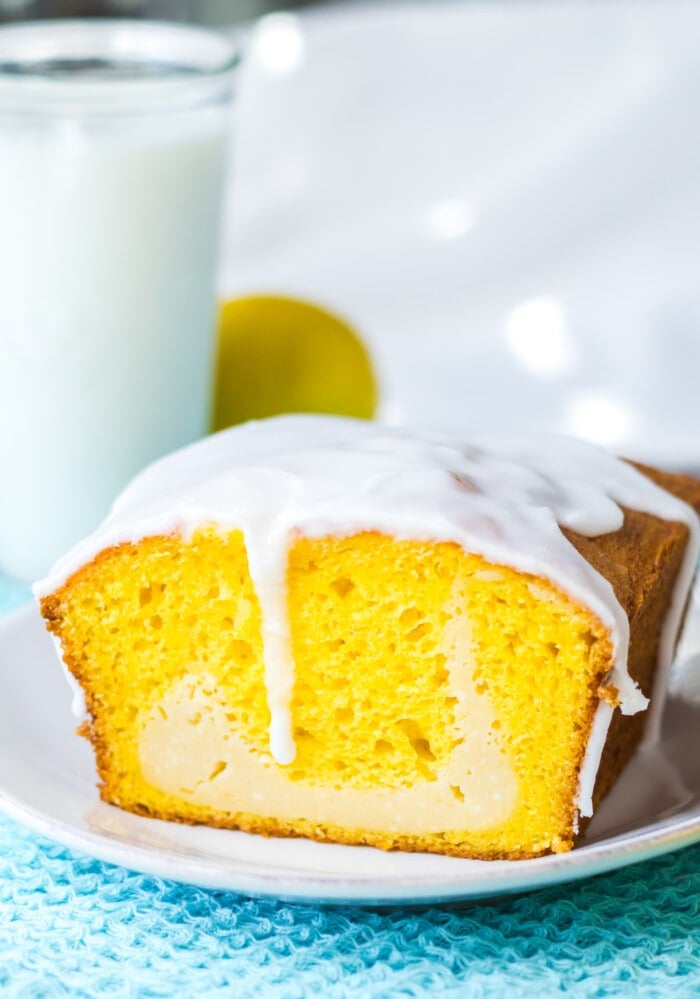 Lemon Loaf with Cream Cheese on a blue place mat.