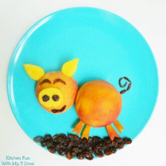 Peach Pig Fruit Snack with raisins on a blue plate0