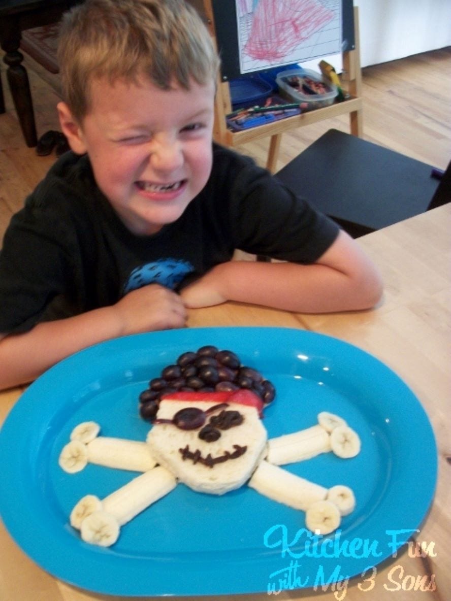 Boy with Pirate Lunch sandwich with grapes and bananas