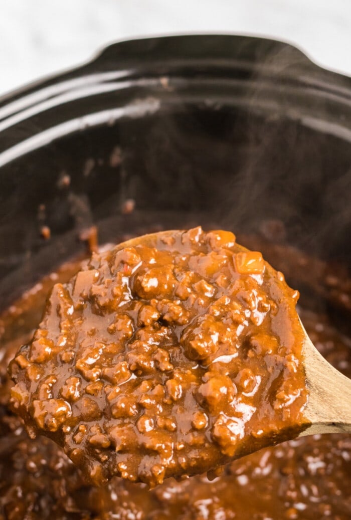wooden spoon with cincinnati chili in slow cooker