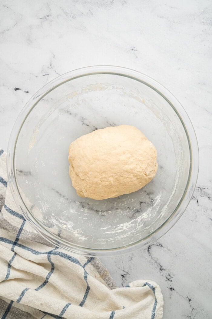 A ball of dough in a glass bowl