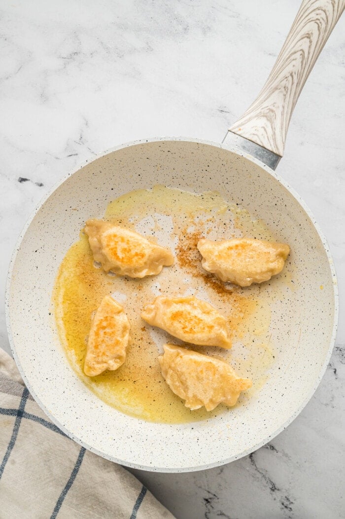 Pierogi in a pan with butter