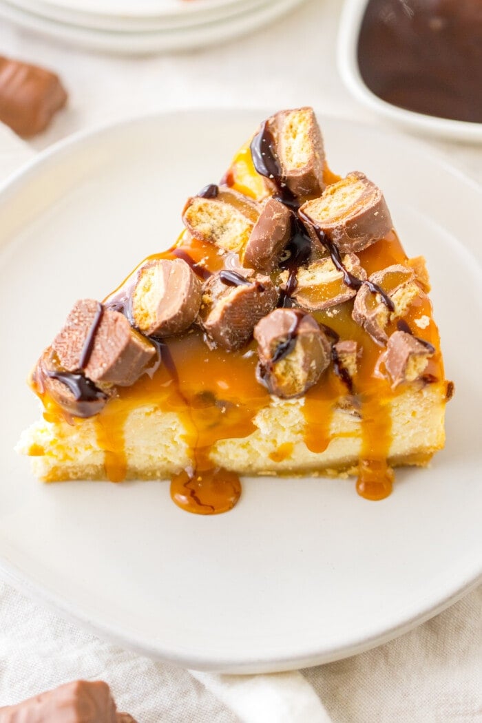 Twix Cheesecake slice with caramel on top.