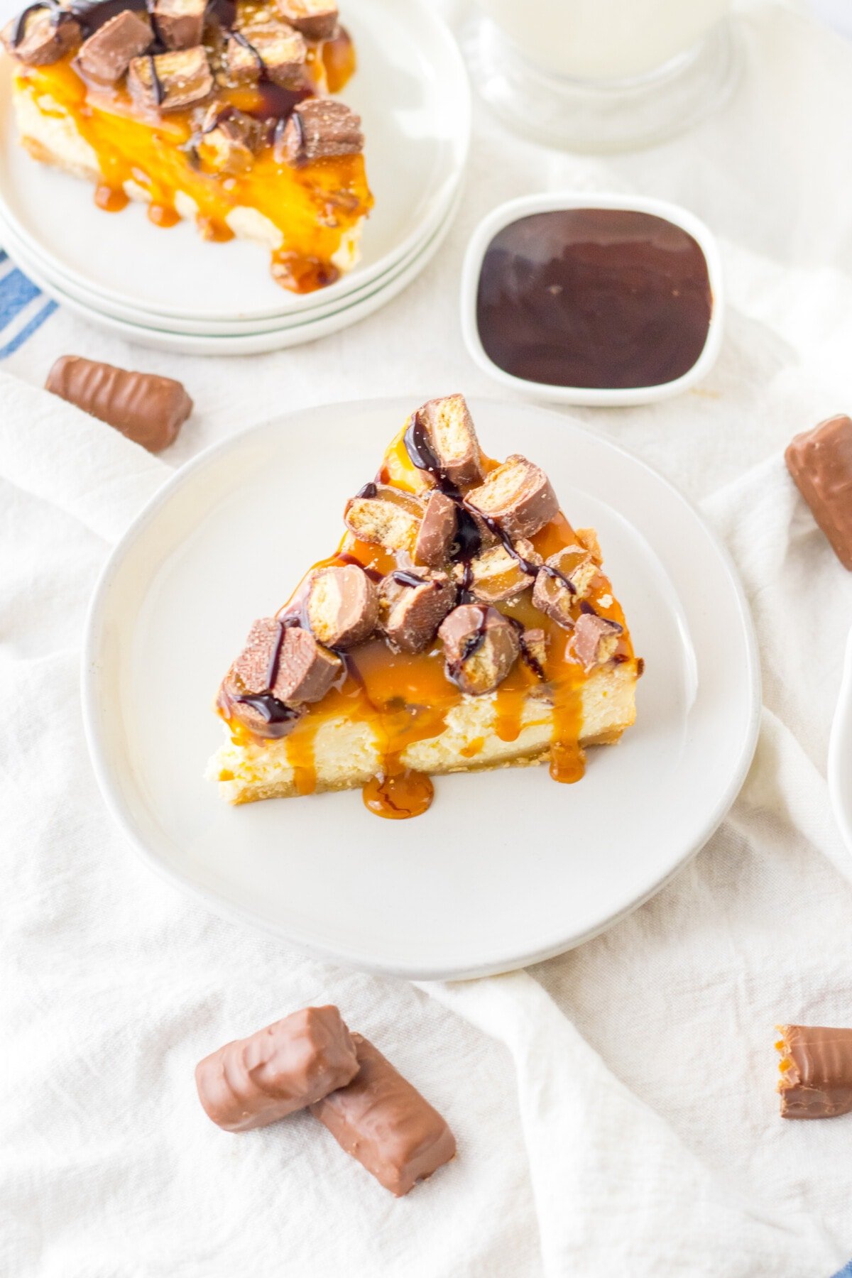 Twix Cheesecake on a white table cloth.