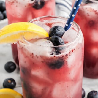 blueberry lemonade in glasses with blue straws