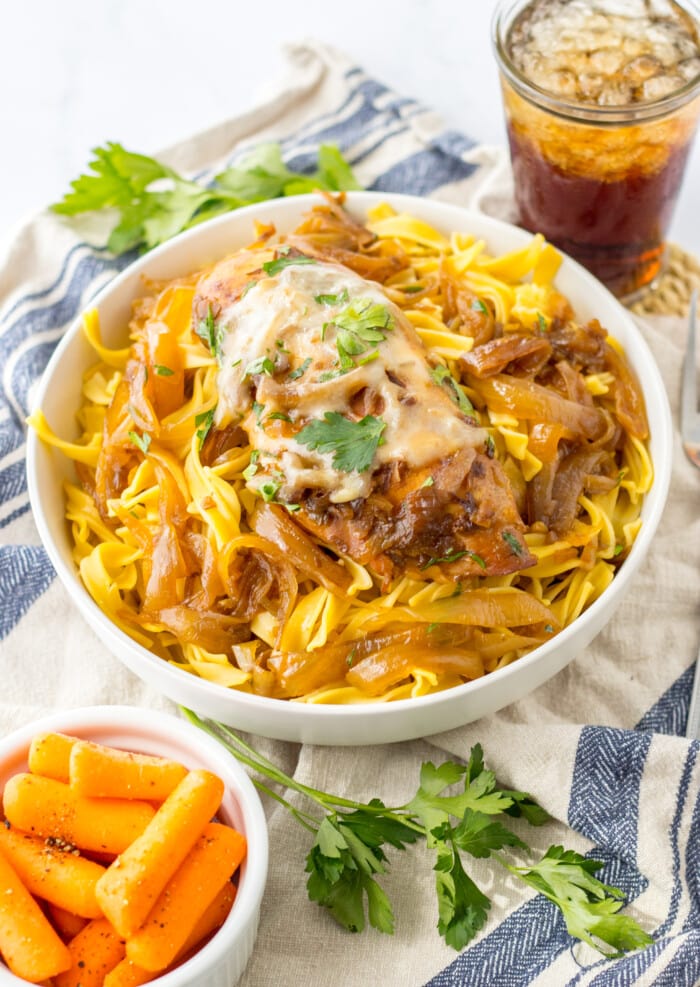 Crockpot French Onion Chicken with a bowl of carrots on the side.