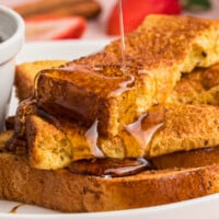 Air fryer French toast sticks topped with syrup