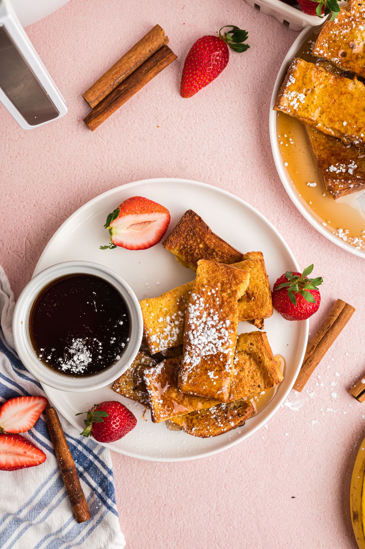 Overhead view of a plate of homemade French toast sticks with syrup