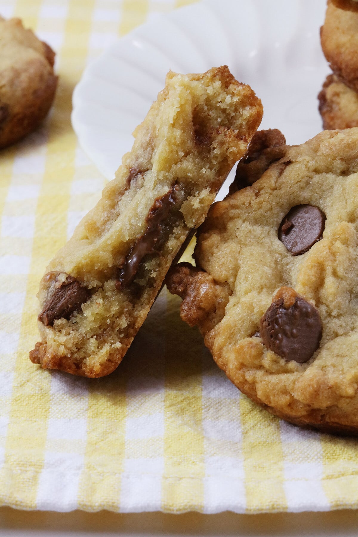 Deep Dish Chocolate Chip Cookies on a yellow and white cloth.