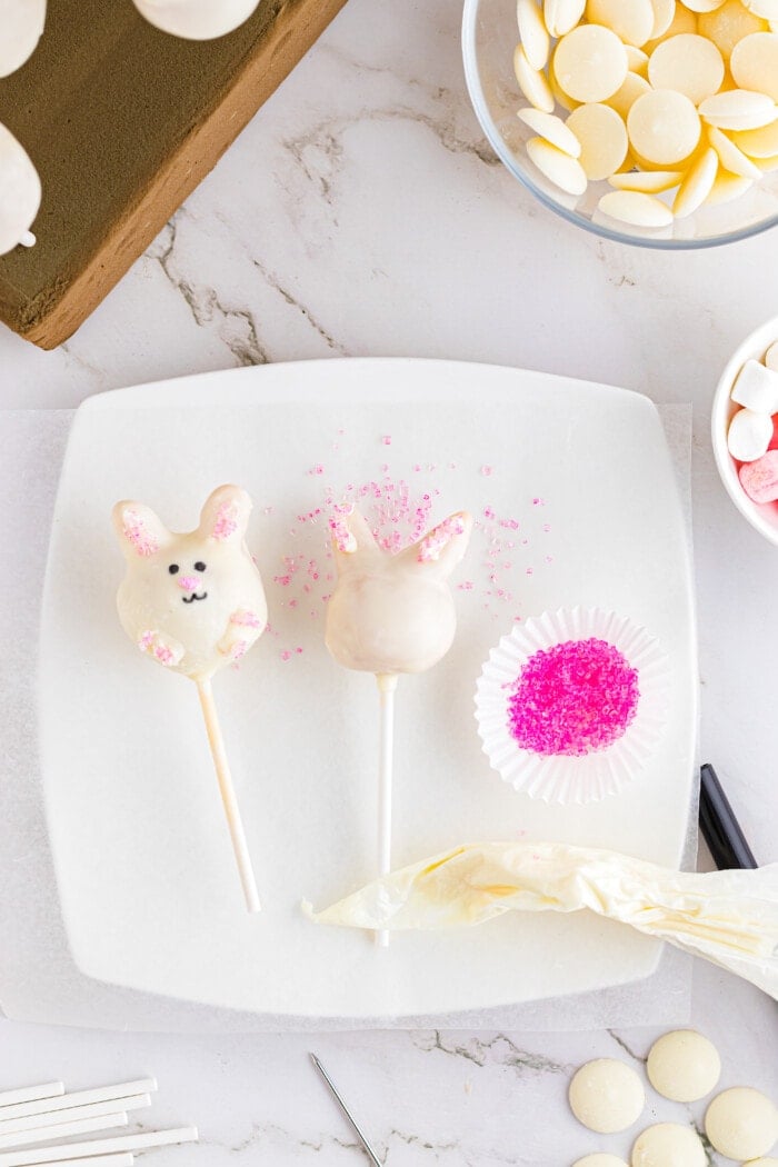 Adding the ears onto the Easter Cake Pops.